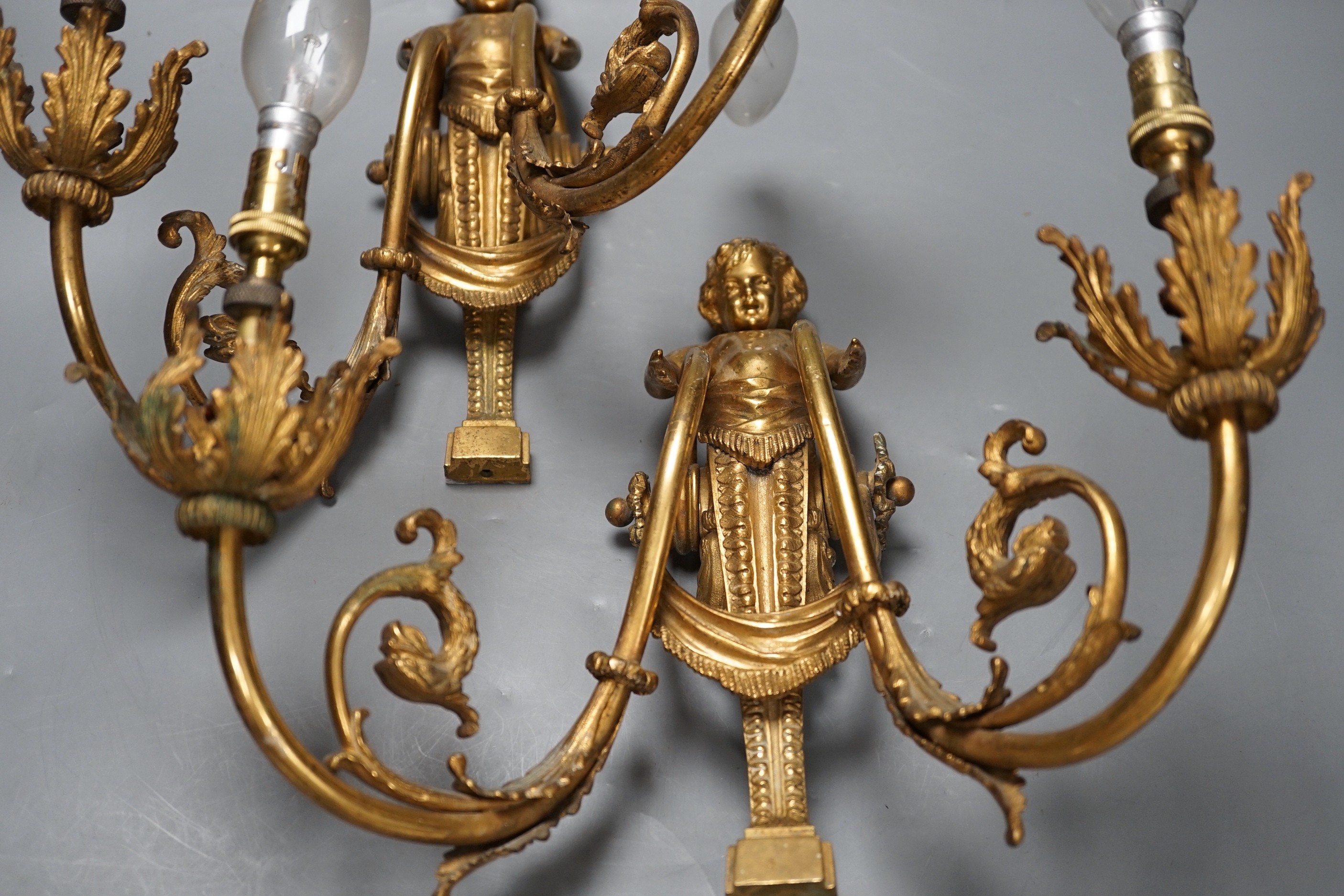 A pair of Louis XVI style ormolu figural twin branch wall lights, 30cm high